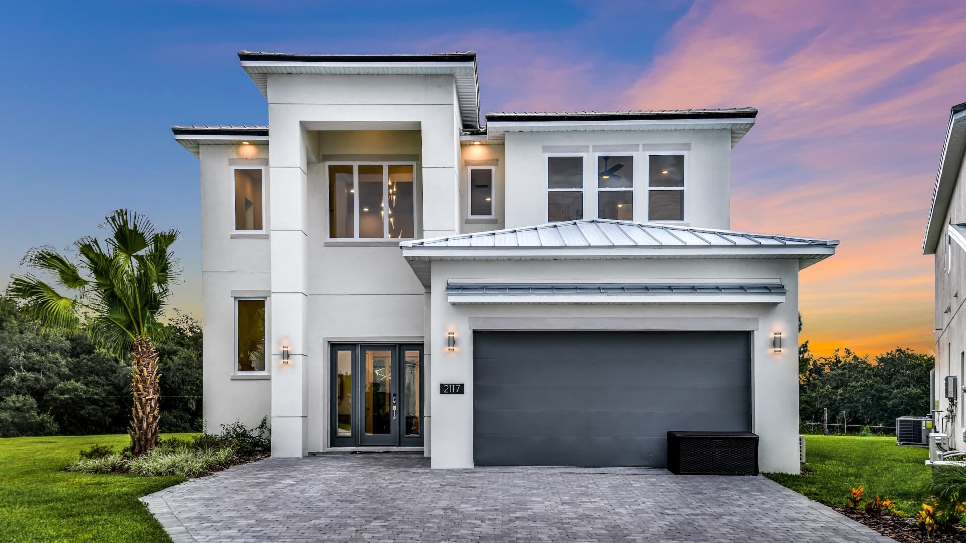 A contemporary house with a garage in The Village, Homes by Villatel